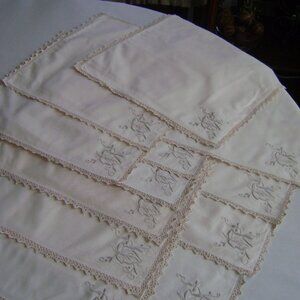 Twelve offwhite napkins,  embroidered with crocheted trim